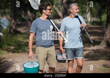 père et fils pêchant sur la rive du lac Banque D'Images