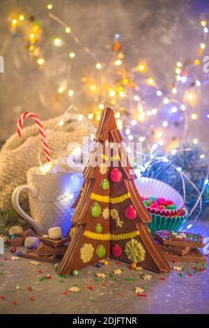 Maison créative chocolat fait à la main en forme d'arbre de Noël avec des décorations, le fond de Noël du nouvel an avec effet de lumières de bokeh Banque D'Images