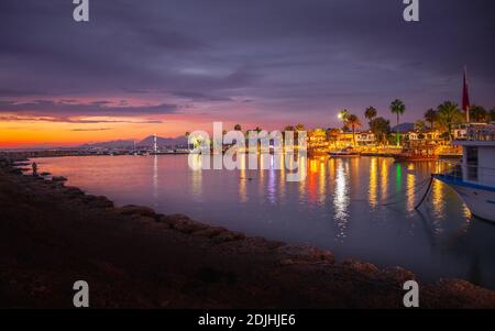 Vue depuis le port de la ville antique de Side, longue exposition et lumières colorées au coucher du soleil dans la Turquie d'Antalya Banque D'Images