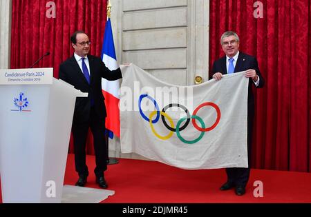 Le président français François Hollande traite le président du CIO Thomas Bach avec un drapeau olympique des Jeux olympiques de 1924 qui ont eu lieu à Paris, lors d'une réception en l'honneur de Thomas Bach au Palais Elysée à Paris, en France, le 02 octobre 2016. Photo de Christian Liewig/ABACAPRESS.COM Banque D'Images