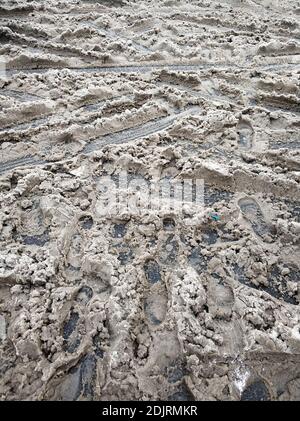 Porridge of snow and grease on the road. Uncleared city roads in winter. Stock Photo