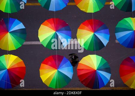 Katmandou, Népal. 15 décembre 2020. Une femme passe devant une bande colorée de parasols mis en place pour l'embellissement le long des rues à Sankata, Nouvelle route à Katmandou, Népal le mardi 15 décembre 2020. Crédit: Skanda Gautam/ZUMA Wire/Alay Live News Banque D'Images