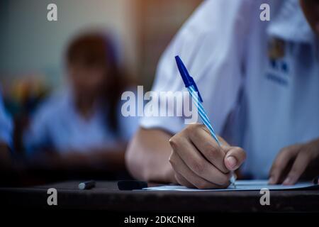Students taking exam with stress in school classroom Stock Photo