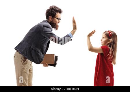 Smiling bearded man holding books and gesturing high-five with a little girl isolated on white background Stock Photo