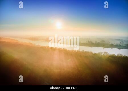 Paysage naturel, Allemagne, Nord de l'Allemagne, Mecklembourg-Poméranie occidentale, Elbe près de Lauenburg, vue aérienne au lever du soleil, heure d'or, ciel coloré, forêt et prairies dans la brume matinale, vue vers Grünendeich en Basse-Saxe Banque D'Images