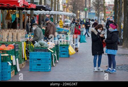 Duisburg, Rhénanie-du-Nord-Westphalie, Allemagne - exigence de masque dans le centre-ville de Duisburg en temps de crise de la couronne pendant la deuxième partie du confinement, les passants avec des masques de protection traversent le marché hebdomadaire sur Koenigstrasse, la principale rue commerçante de la zone piétonne. Banque D'Images