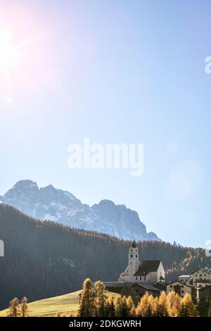 the village of Colle Santa Lucia with the church on the hill in autumn, belluno Province, Dolomites, Veneto, Italy Stock Photo