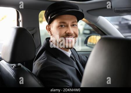 Beau chauffeur conduisant une voiture de luxe Banque D'Images