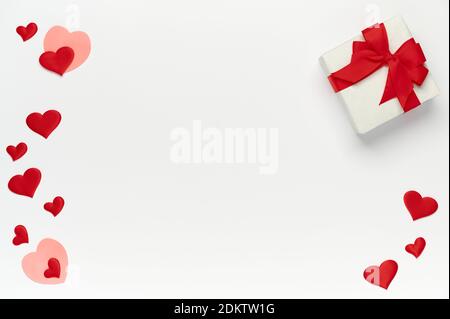 Saint Valentine concept, top view of colored hearts and gift box on white isolated with place for text background Stock Photo