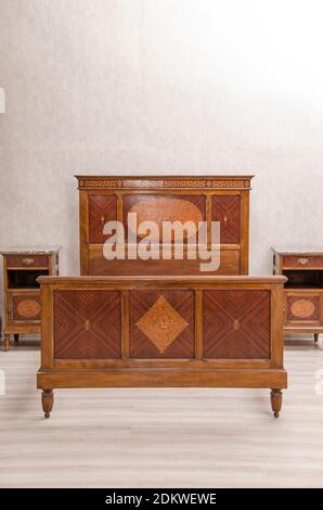 Antique vintage bedroom furniture: antique bed and bed table. Western Europe. Early 20th century Stock Photo