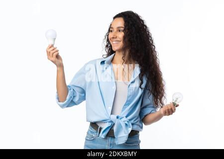 Femme gaie tenant des ampoules utilisées sur fond blanc Banque D'Images