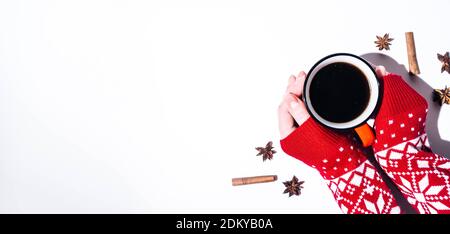 Les mains d'une femme dans un chandail rouge tenant une tasse de café, vue du dessus. Isolé sur un arrière-plan blanc avec espace de copie. Banque D'Images