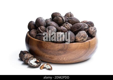 Heap  of freshly harvested english walnuts in the wooden plate Stock Photo