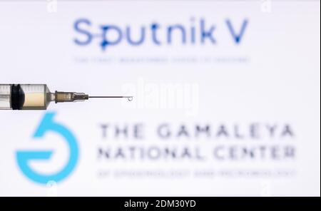 Kathmandu, Nepal - December 15 2020: Closeup of Syringe Injection full of vaccine against Sputnik V Gamaleya Logo. Stock Photo