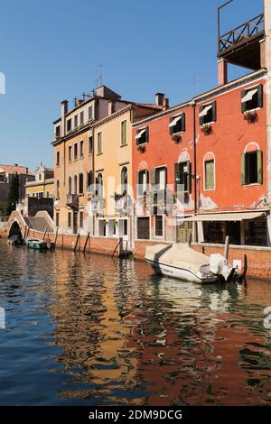 Narrow canal with moored boats and Renaissance architectural style residential buildings, Dorsoduro district, Venice, Veneto, Italy. Stock Photo