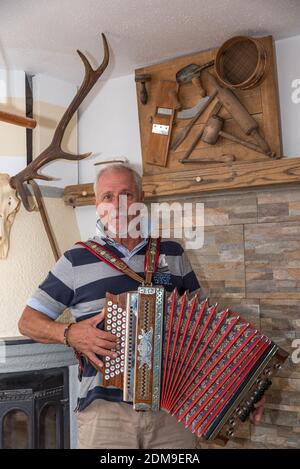 Musician Plays Accordion In Old Farmhouse Parlor Stock Photo