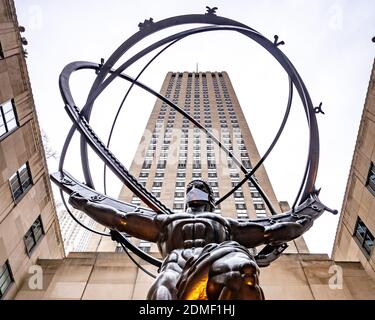 New York, États-Unis, 16 décembre 2020. La célèbre statue en bronze de l'Atlas portant le ciel circulaire du Rockefeller Center porte un masque pour symboliser New York Banque D'Images