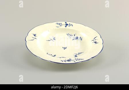 Soup Plate, Chantilly Porcelain Manufactory, French, active ca. 1725 - ca. 1789, soft paste porcelain, vitreous enamel, Straight marly with shaped edge, with underglaze blue line. Sprigs of flowers in underglaze blue in cavetto and on marly., France, ca. 1770, ceramics, Decorative Arts, plate, plate Stock Photo