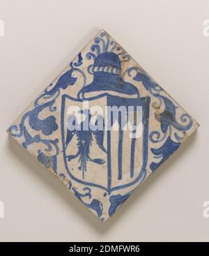 Floor tile, Glazed and painted earthenware, Square tile of buff clay with thin underfired opaque grayish-white glaze. Underglaze blue painting of diagonally placed heraldic shield with eagle and three pointed arches. Above, helmet with plumes, and foliated scrolls surrounding the shield., possibly Portugal, 16th–early 17th century, tiles, Decorative Arts, Floor tile Stock Photo