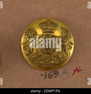 Button, Brass, Button showing coat of arms: heraldic devices surrounded by a band with 'Honi soit qui mal y pense', lion and unicorn supporters, crown above and below, ribbon with 'Treu und fest.' Brass back and shank. On reverse, 'Firmin and Son 153 Strand, London.', On card i80, England, 19th century, costume & accessories, Decorative Arts, Button Stock Photo