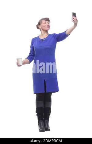 Beautiful blonde caucasian woman with takeaway coffee taking a selfie Banque D'Images