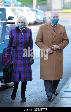 The Prince of Wales and the Duchess of Cornwall arrive to meet with front line health and care workers administering and receiving the Covid-19 vaccine during a visit to the Gloucestershire Vaccination Centre at Gloucestershire Royal Hospital. Stock Photo