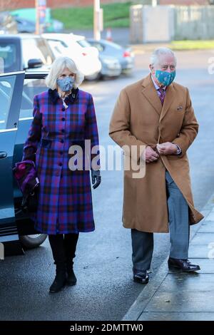 The Prince of Wales and the Duchess of Cornwall arrive to meet with front line health and care workers administering and receiving the Covid-19 vaccine during a visit to the Gloucestershire Vaccination Centre at Gloucestershire Royal Hospital. Stock Photo