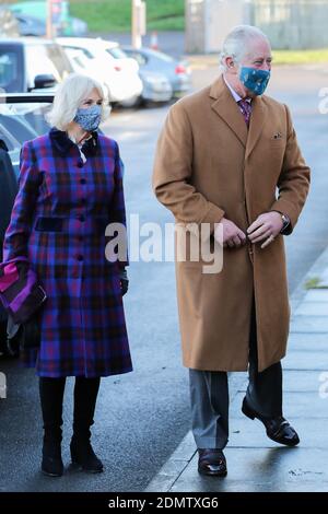 The Prince of Wales and the Duchess of Cornwall arrive to meet with front line health and care workers administering and receiving the Covid-19 vaccine during a visit to the Gloucestershire Vaccination Centre at Gloucestershire Royal Hospital. Stock Photo