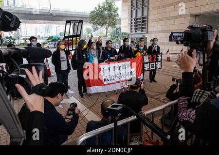 Pro-democracy activists (L-R) Former lawmaker Leung Kwok-hung, also known as Long Hair, convener of civil human rights front Figo Chan, former lawmaker Eddie Chu and district councillor Tsang Kin-shing holding a banner ahead of the court hearing.Pro-democracy activists arrive at the West Kowloon Magistrates' Court for charges of the illegal assembly in connection with a protest on 1st July 2020. Stock Photo