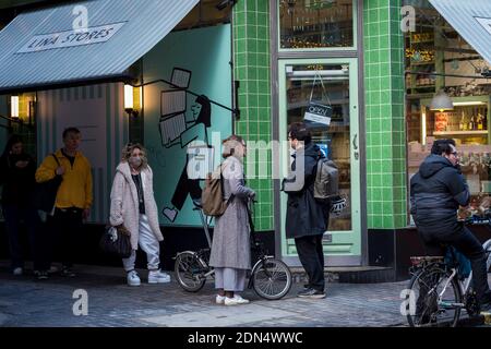 London, UK.  17 December 2020. People queue for purchases outside a grocery store in Soho as the capital experiences Tier 3, Very High Alert Level, restrictions while the coronavirus pandemic continues.  Credit: Stephen Chung / Alamy Live News Stock Photo