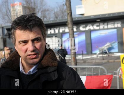 Urgentist and contributor to French satirical magazine Charlie Hebdo Patrick Pelloux poses on January 23, 2015 outside the Hyper Casher shop in Paris, France, prior to a march of freedom organised toward the satirical newspaper Charlie Hebdo offices, two weeks after the attacks in these two Paris places that left 16 dead plus one policewoman in Montrouge, a Paris suburb. France unveiled a raft of measures on January 21, 2015 to curb radicalisation and better monitor jihadists two weeks after an Islamist killing spree in Paris that sent shockwaves across Europe. The banner reads : 'March for fr Stock Photo