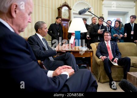 U.S. President Barack Obama, center, speaks during a meeting with Ashton Carter, U.S. secretary of defense, right, and U.S. Vice President Joseph Joe Biden, left, in the Oval Office of the White House in Washington, DC, USA, on Tuesday, February 17, 2015. Carter, sworn in as defense secretary today, inherits an array of defense and foreign policy challenges that are likely to help define the remaining two years of Obama’s presidency. Photo by Andrew Harrer/Pool/ABACAPRESS.COM Stock Photo