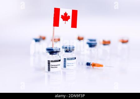 Coronavirus (COVID-19) vaccine vials with the flag of Canada. Stock Photo
