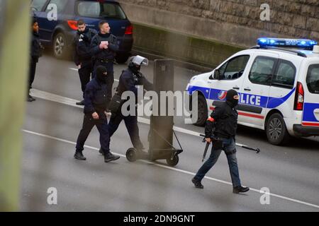 Police forces gather nearby Porte de Vincennes, east of Paris, after at least one person was injured when a gunman opened fire at a kosher grocery store on January 9, 2015 and took at least five people hostage. The attacker was suspected of being the same gunman who killed a policewoman in a shooting in Montrouge in southern Paris, France on January 8. Photo by Nicolas Briquet/ABACAPRESS.COM Stock Photo