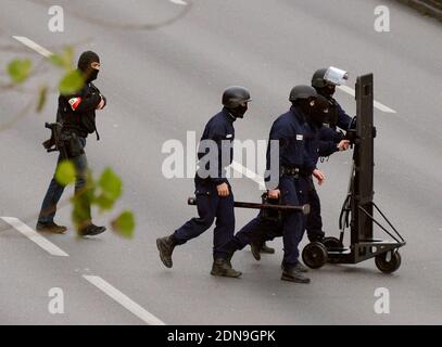 Police forces gather nearby Porte de Vincennes, east of Paris, after at least one person was injured when a gunman opened fire at a kosher grocery store on January 9, 2015 and took at least five people hostage. The attacker was suspected of being the same gunman who killed a policewoman in a shooting in Montrouge in southern Paris, France on January 8. Photo by Nicolas Briquet/ABACAPRESS.COM Stock Photo