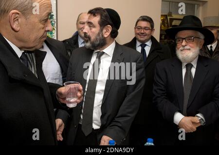 French Defence Minister Jean-Yves Le Drian (L) stands next to Joel Mergui (C), president of the Central Jewish Consistory of France, at the Grand Synagogue of Paris on January 16, 2015, as he inspects the Vigipirate plan (France's national security alert system) in place at various sites throughout the city. The anti-terrorism Vigipirate plan which has been reinforced in the wake of recent attacks will be maintained in France 'as long as risk prevails', Cazeneuve said on January 16. Photo Pool by Joel Saget/ABACAPRESS.COM Stock Photo