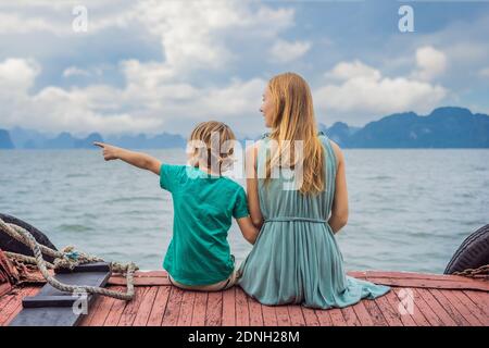 Mom and son travelers is traveling by boat in Halong Bay. Vietnam. Travel to Asia, happiness emotion, summer holiday concept. Traveling with children Stock Photo