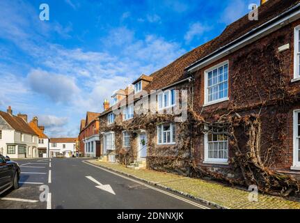 Georgian style terraced cottage (Church Hill House) in Church Hill, Midhurst, West Sussex, in winter with a Christmas wreath on its blue front door Stock Photo