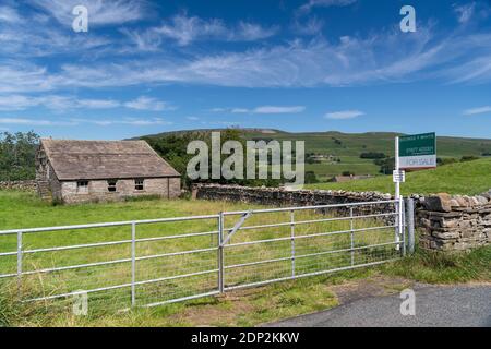 A vendre signe sur petit pâturage et bâtiment dans le Yorkshire Dales, idéal pour la conversion de grange. North Yorkshire, Royaume-Uni. Banque D'Images