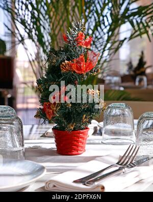 Table de salle à manger avec couverts complets et décoration d'arbre de Noël Banque D'Images