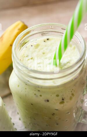 smoothie vert sain avec épinards, céleri et banane dans des pots en verre, image verticale Banque D'Images