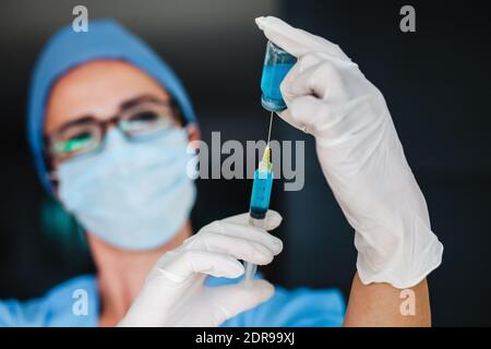 Femme latine médecin tenant une injection de vaccin pour le coronavirus covid 19 La vaccination mondiale en Amérique latine Banque D'Images