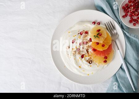 Dessert coloré doux et sain, salade de fruits mélangée avec yaourt à la noix de coco. Espace de copie, vue de dessus Banque D'Images
