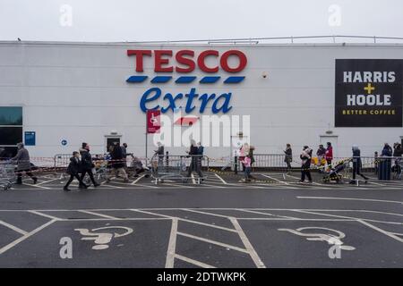 Watford, Royaume-Uni. 22 décembre 2020. Les clients font la queue à l'extérieur de la superboutique supplémentaire Tesco à Watford, dans le Hertfordshire. Le comté, ainsi qu'une grande partie du Royaume-Uni, est dans le Tier 4, restent à la maison, le niveau d'alerte étant donné que la pandémie du coronavirus se poursuit et la détection d'une nouvelle souche mutante exerce des pressions sur le gouvernement britannique pour qu'il mette en place un verrouillage national. Les craintes d'un manque de nourriture fraîche ont commencé à acheter panique dans certaines régions. Credit: Stephen Chung / Alamy Live News Banque D'Images