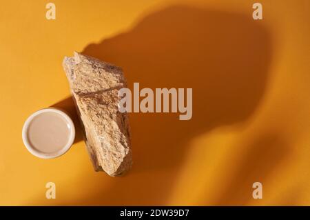 Podium en verre rond et pierre sur fond jaune avec ombres, place pour votre produit Banque D'Images