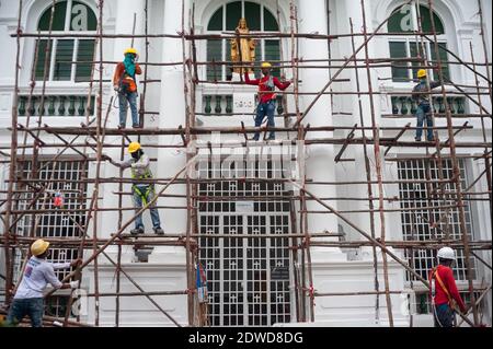 21.12.2020, Singapour, République de Singapour, Asie - après les travaux de rénovation, un groupe de travailleurs de la construction démonte un échafaudage en bois. Banque D'Images