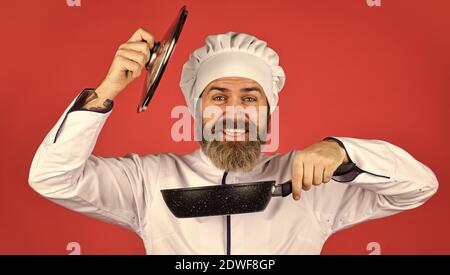 Récipient en céramique. Préparer la nourriture dans la cuisine. Concept de cuisine. Poêle à frire de haute qualité. Homme barbu cuisinier uniforme blanc. Cuisine comme pro. Repas savoureux et facile préparé à la maison. Petit-déjeuner fait maison. Banque D'Images