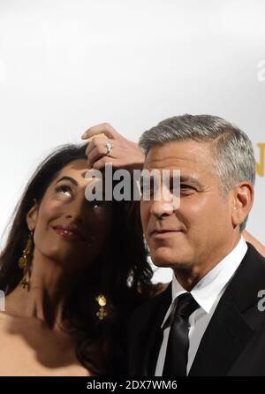 L'acteur-réalisateur AMÉRICAIN George Clooney arrive avec sa fiancée, Amal Alamuddin, avocat britannique-libanais des droits de l'homme, pour la nuit de la fête des célébrités au Palazzo Vecchio à Florence, Italie, le 7 septembre 2014. L'événement caritatif bénéficie à la Fondation Andrea Bocelli et au Centre Muhammad Ali Parkinson. Photo par Eric Vandeville/ABACAPRESS.COM Banque D'Images