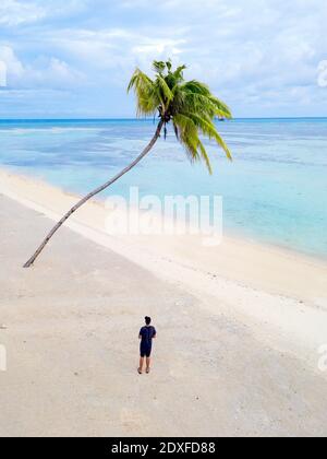Maldives, atoll de Kaafu, vue aérienne de l'homme debout seul sur la plage de sable côtier de l'île d'Huraa Banque D'Images