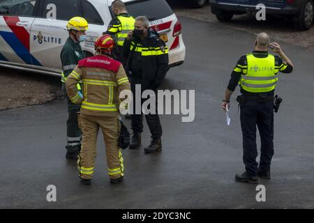 ZUTPHEN, PAYS-BAS - 08 décembre 2020: Commandant du service des incendies et officiers de police dans des masques délibératant et organisant sur une scène d'accident W Banque D'Images